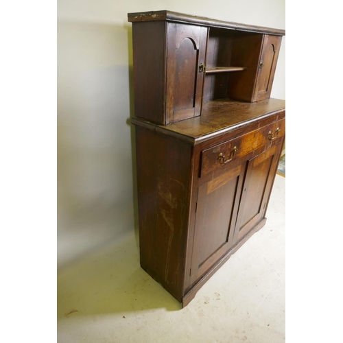 1147 - A C19th mahogany chiffonier, with two cupboards flanking a pen shelf, and a single drawer over two c... 