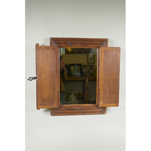 1154 - A hardwood mirror in the form of shutters, 44 x 59cm