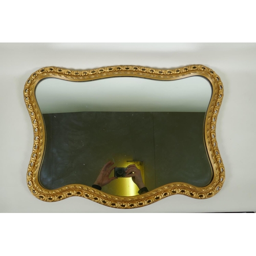 1156 - A shaped gilt wall mirror, 68 x 48cm