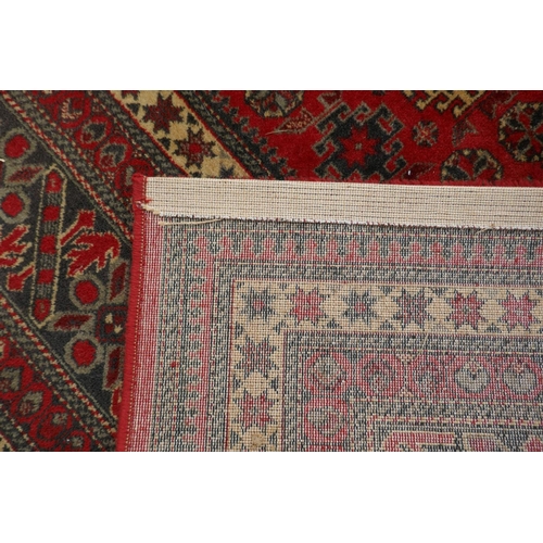 1159 - A large Belgian red ground wool rug with Persian design, 294 x 366cm