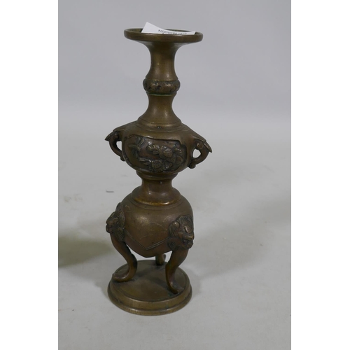 116 - A pair of Oriental brass pricket candlesticks, raised on tripod supports, 20cm high