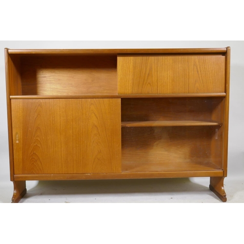 1164 - A mid century Nathan teak bookcase with open shel and fall front over two sliding doors, raised on s... 