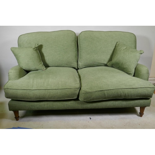 1166 - A Howard style two seater settee in green linen upholstery, 170cm wide