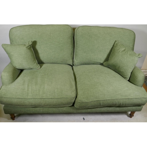 1166 - A Howard style two seater settee in green linen upholstery, 170cm wide