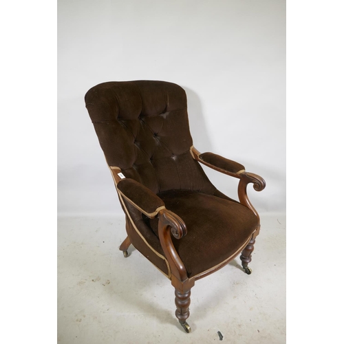 1167 - A Victorian mahogany framed open arm chair with button back and carved scroll arms, raised on turned... 