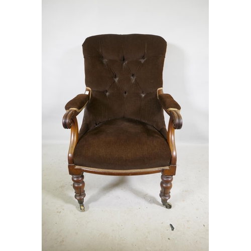 1167 - A Victorian mahogany framed open arm chair with button back and carved scroll arms, raised on turned... 