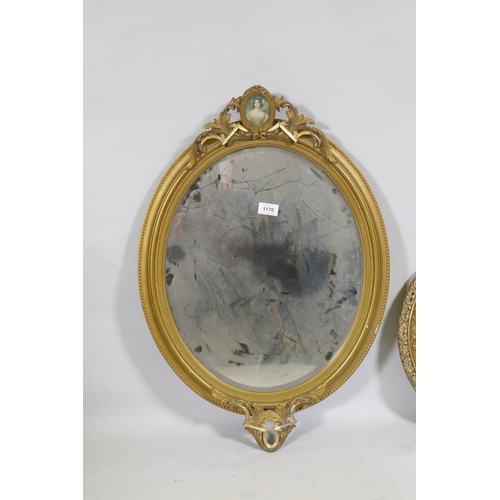 1170 - A vintage gilt oval wall mirror, 72cm high, and a later circular convex mirror