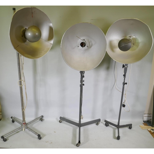 1172 - A pair of industrial RRB floor standing studio lamps, and a similar Malham lighting equipment SE23 s... 