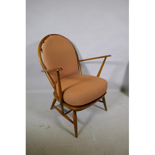 1176 - A vintage Ercol elm Fleur de Lys armchair