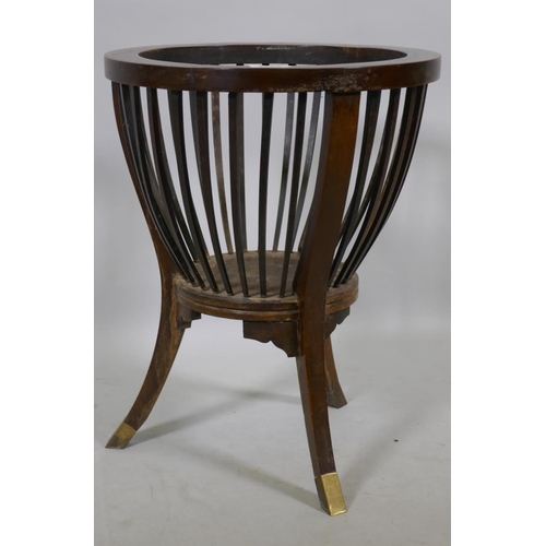 1178 - An antique mahogany basket planter holder with slatted body raised on sabre supports with brass lips... 