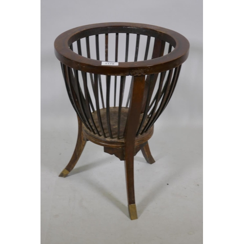 1178 - An antique mahogany basket planter holder with slatted body raised on sabre supports with brass lips... 