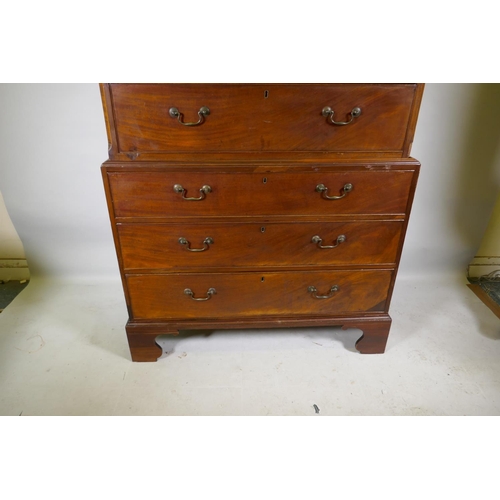 1186 - A Georgian mahogany chest on chest in two sections, with dentil cornice over a blind frieze and two ... 