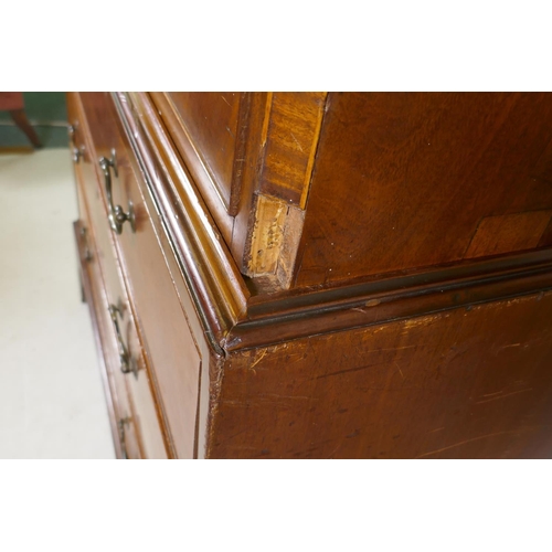 1186 - A Georgian mahogany chest on chest in two sections, with dentil cornice over a blind frieze and two ... 