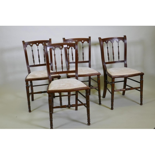 1198 - Four C19th beechwood and walnut side chairs with Gothic style backs, raised on turned tapering suppo... 