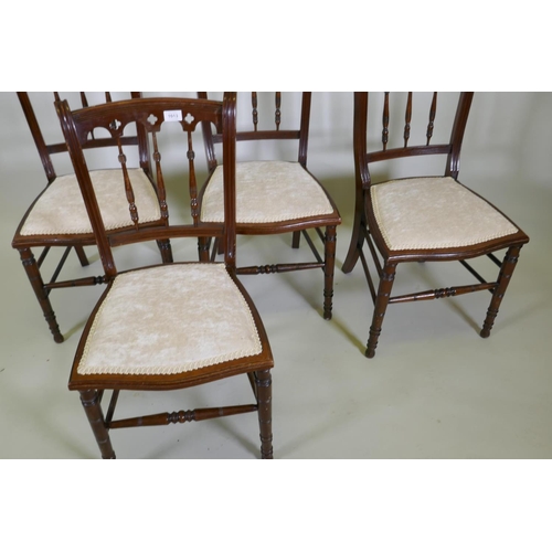 1198 - Four C19th beechwood and walnut side chairs with Gothic style backs, raised on turned tapering suppo... 