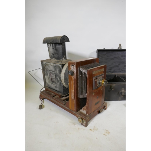 123 - A Thornton Pickard Standard plate camera, with tripod supports, mahogany plate cases, a Coronet Enla... 