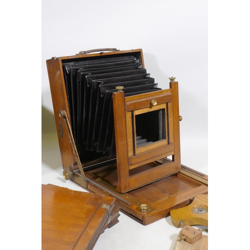 123 - A Thornton Pickard Standard plate camera, with tripod supports, mahogany plate cases, a Coronet Enla... 