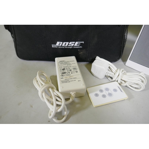 127 - A Bose Sound Dock digital music system, with charger, remote and carry case, and a Roberts sound 80 ... 