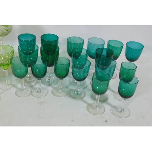 128 - A quantity of matched green and yellow cut wine glasses, and green drinking glasses