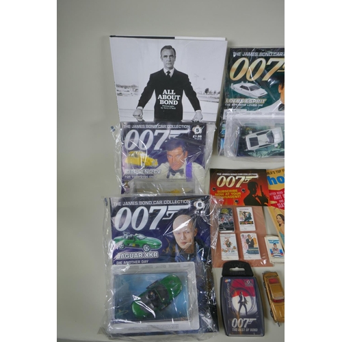 134 - A quantity of James Bond collectors' items to include magazines, reproduction plastic guns, match bo... 