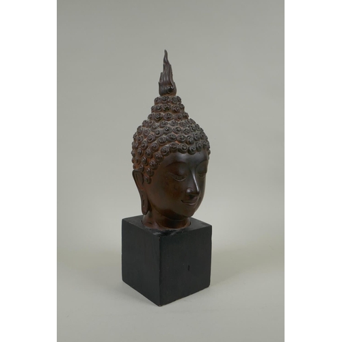 136 - A Thai bronzed metal head bust of Buddha, on a display stand, 35cm high