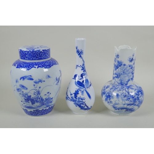 139 - Two Japanese Meiji period blue and white porcelain vases decorated with birds amongst flowers and br... 