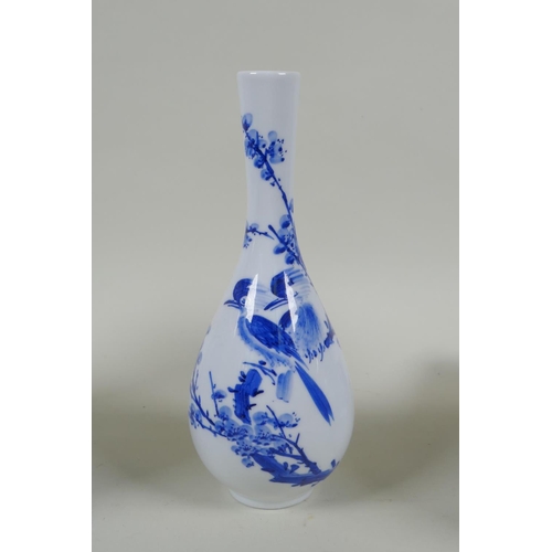 139 - Two Japanese Meiji period blue and white porcelain vases decorated with birds amongst flowers and br... 