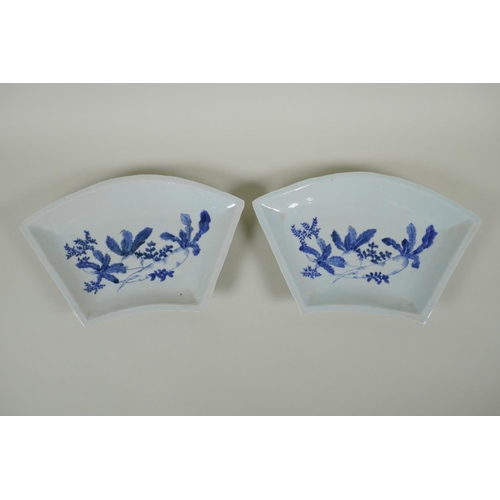 143 - A pair of C19th Japanese blue and white porcelain fan shaped dishes decorated with root vegetables, ... 