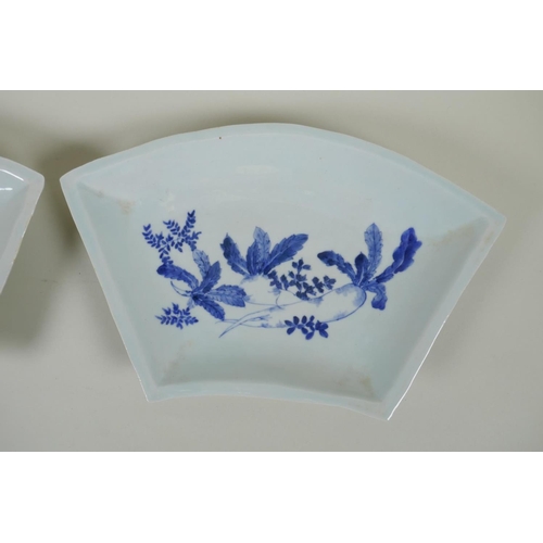 143 - A pair of C19th Japanese blue and white porcelain fan shaped dishes decorated with root vegetables, ... 