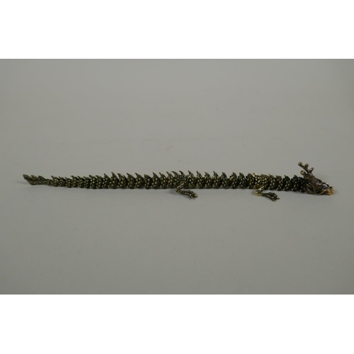 147 - A Japanese Jizai style articulated bronze okimono dragon, 22cm long