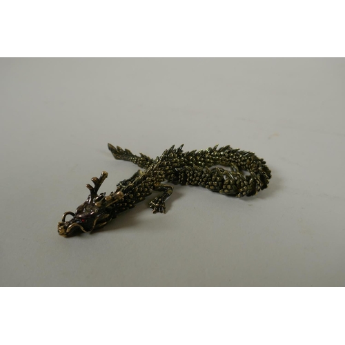 147 - A Japanese Jizai style articulated bronze okimono dragon, 22cm long