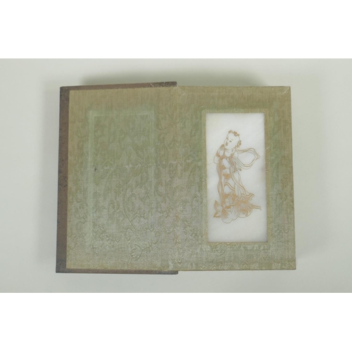 148 - A Chinese wood and silk bound book with white jade tablet pages bearing chased and gilt inscriptions... 