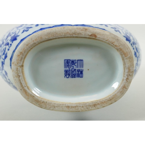 150 - A Chinese blue and white porcelain two handled moon flask, decorated with dragon, phoenix and lotus ... 