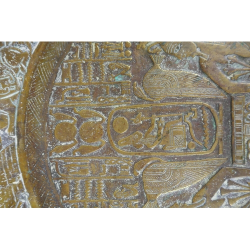 154 - An antique heavy Egyptian  bronze tray decorated with depictions of pharaoh and hieroglyphics, ... 