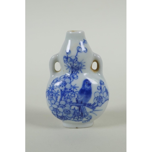 163 - A Chinese blue and white porcelain double gourd two handled snuff bottle decorated with birds amongs... 