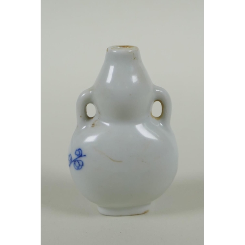 163 - A Chinese blue and white porcelain double gourd two handled snuff bottle decorated with birds amongs... 