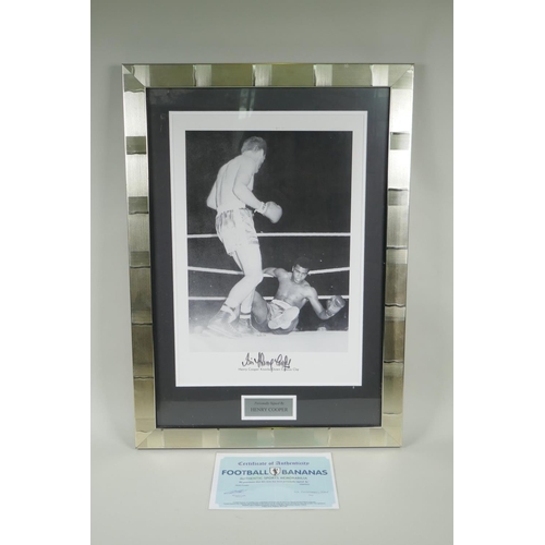 166 - A framed signed photographic print of Henry Cooper knocking down Cassius Clay (Mohammed Ali) with Ce... 