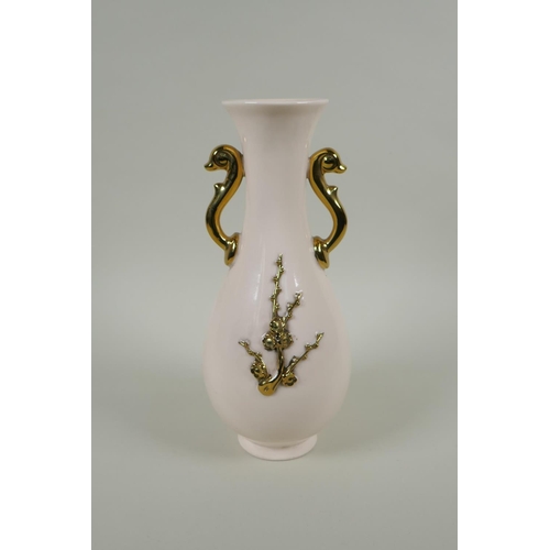 168 - A Chinese cream glazed porcelain pear shaped vase with two gilt handles and raised prunus decoration... 