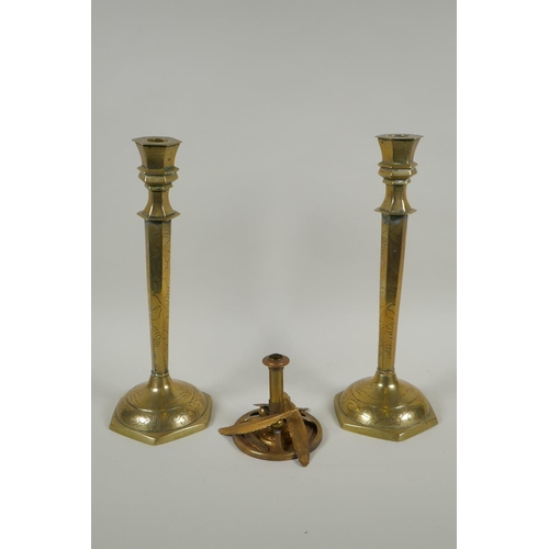 169 - A studio art coper and brass hand assembled candle stick, decorated with feathers, signed to the bas... 