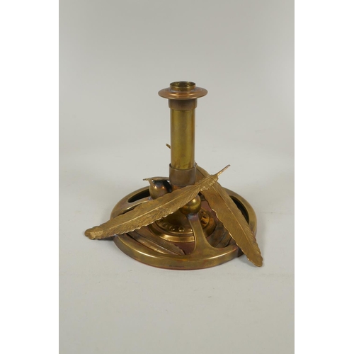 169 - A studio art coper and brass hand assembled candle stick, decorated with feathers, signed to the bas... 