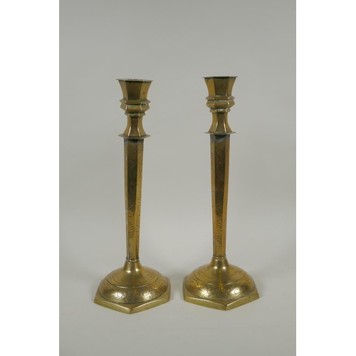 169 - A studio art coper and brass hand assembled candle stick, decorated with feathers, signed to the bas... 