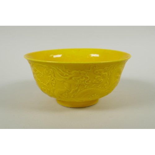 171 - A Chinese yellow ground porcelain bowl with raised dragon decoration, Yong Zheng 6 character mark to... 