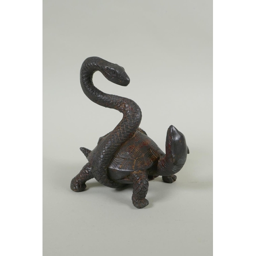 173 - A Chinese filled bronze figure of a tortoise entwined with a snake, with the remnants of gilt patina... 