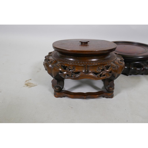 179 - Nine Chinese hardwood vase stands with carved lotus decoration, and a carved jar cover