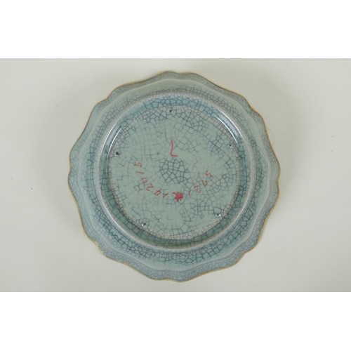 195 - A Chinese celadon crackleware bowl of lobed form, with a gilt metal rim and chased character inscrip... 