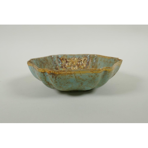 200 - A Chinese celadon ground porcelain dish with a lobed gilt metal rim and applied gilt metal bird and ... 