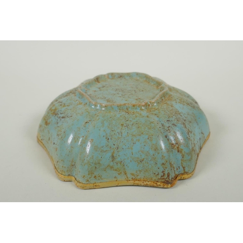 200 - A Chinese celadon ground porcelain dish with a lobed gilt metal rim and applied gilt metal bird and ... 