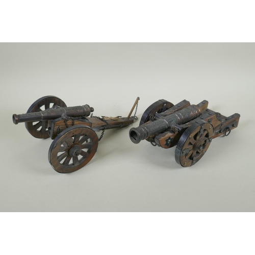 203 - Two wood and metal table canons, 32cm long