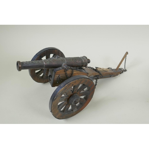 203 - Two wood and metal table canons, 32cm long