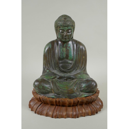 204 - A Chinese patinated bronze figure of Buddha seated in meditation, on a carved hardwood stand, 31cm h... 